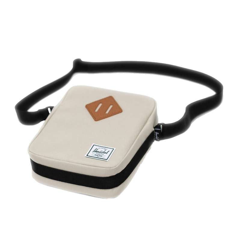 Herschel Heritage crossbody bag with a compact design, front pocket, adjustable strap, and signature diamond detail for everyday use.