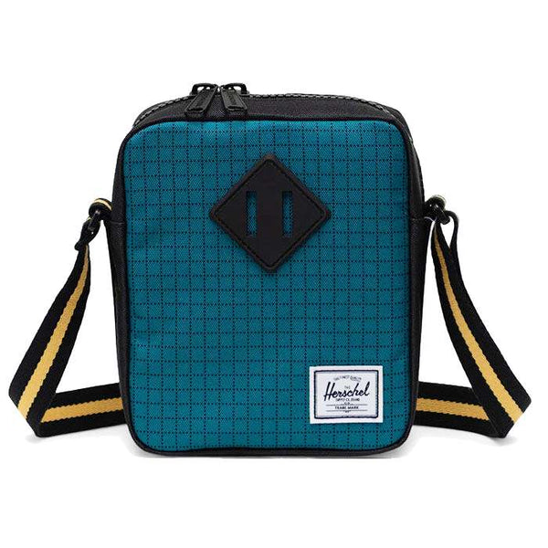Herschel Heritage crossbody bag with a compact design, front pocket, adjustable strap, and signature diamond detail for everyday use.