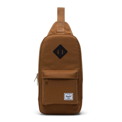 Herschel Heritage shoulder bag with a compact crossbody design, front zip pocket, adjustable strap, and signature diamond detail for everyday use.