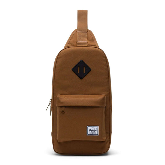 Herschel Heritage shoulder bag with a compact crossbody design, front zip pocket, adjustable strap, and signature diamond detail for everyday use.