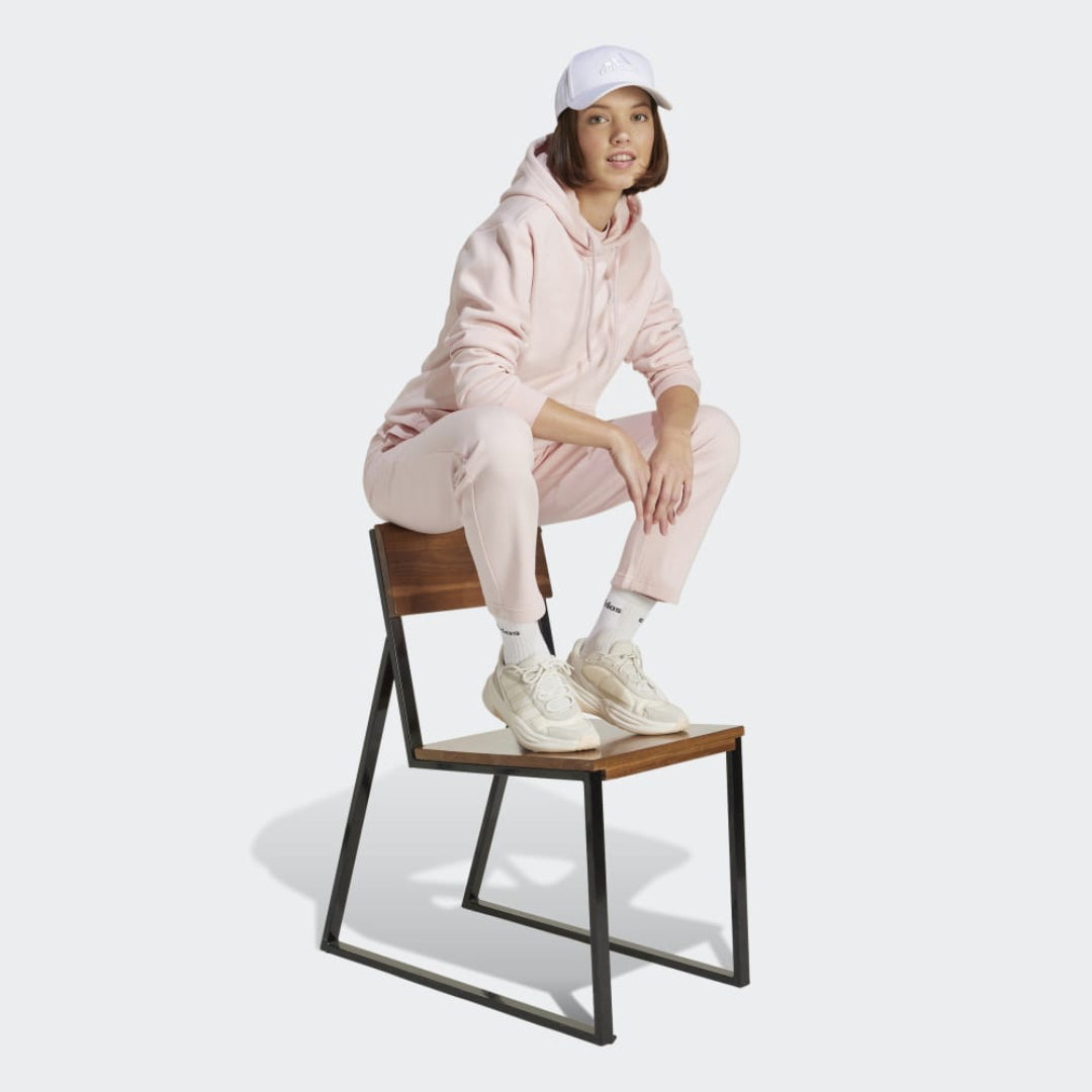 adidas Women's Essentials Small Logo Feel Cozy Hoodie in a relaxed fit, perfect for comfort and style.