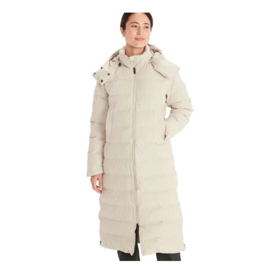 Woman wearing Marmot Prospect long down coat with hood, featuring a full-length insulated design, waterproof fabric, and sleek winter styling for cold-weather protection