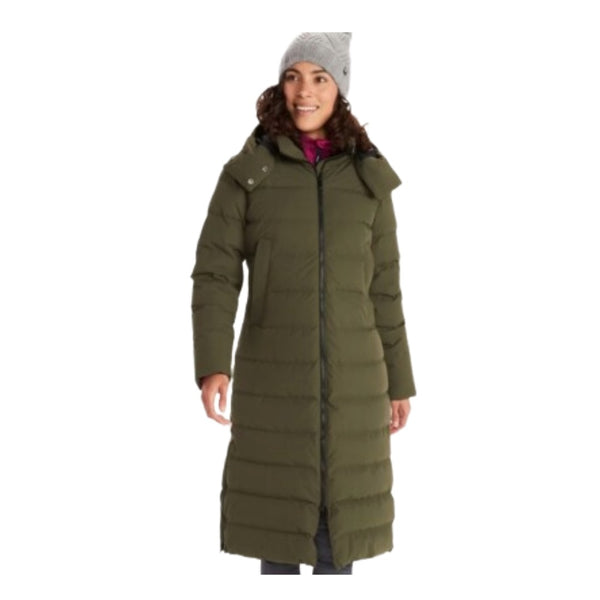 Woman wearing Marmot Prospect long down coat with hood, featuring a sleek full-length design, insulated construction, and waterproof fabric for winter protection