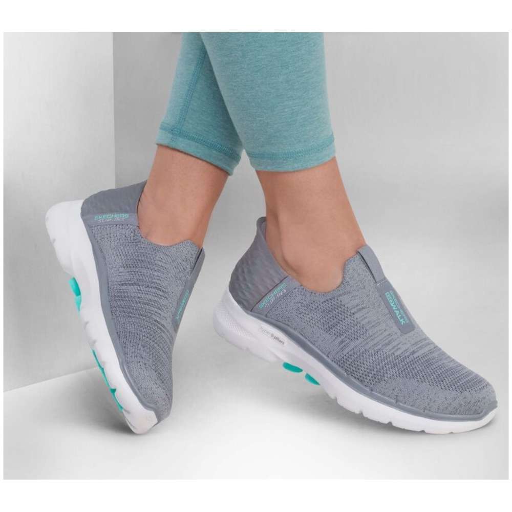 A pair of Skechers Women's Slip-ons Go Walk 6 in gray. The shoes feature a slip-on design and a comfortable, cushioned sole. The Skechers logo is visible on the side of each shoe.