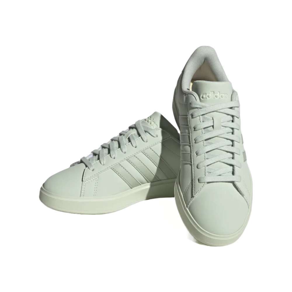 A pair of leather sneakers with Adidas stripes on the sides, featuring a comfortable and stylish design suitable for casual and athletic wear