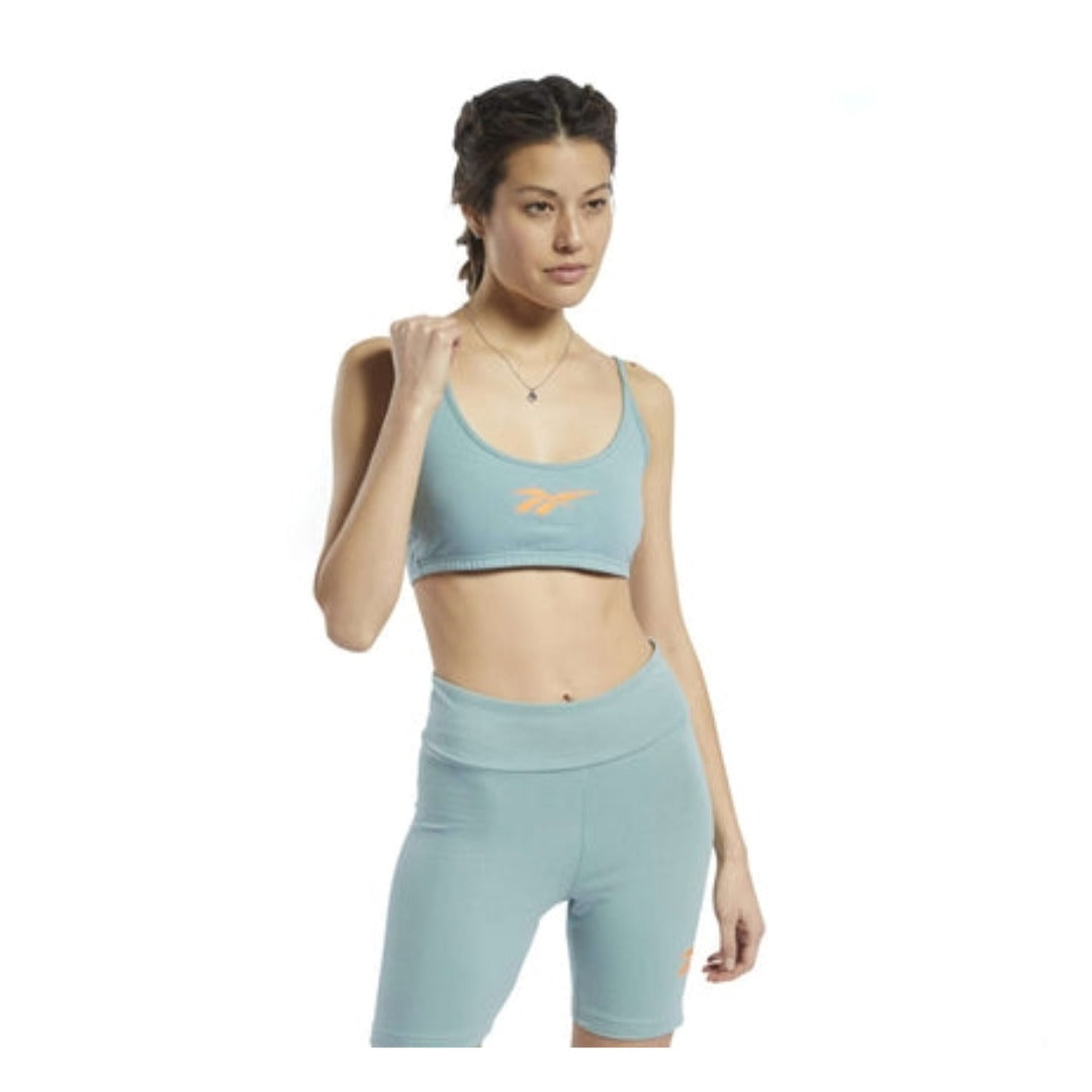 Women’s sports bra featuring a stretchy fabric construction, supportive elastic underband, racerback design, bold front logo graphic, and comfortable fit for low-impact activities