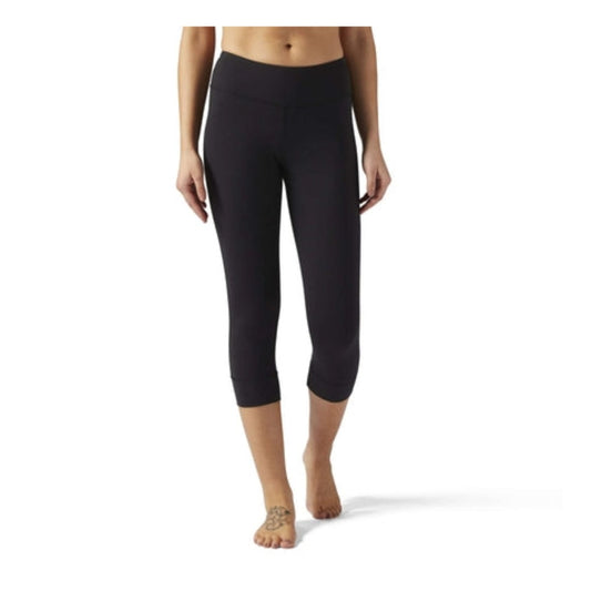Women’s 3/4-length workout tights featuring stretch performance fabric, a supportive high-rise waistband, moisture-wicking construction, and a fitted athletic silhouette for training and fitness activities
