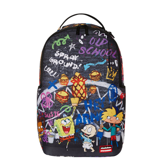 Sprayground DLXR Backpack featuring 1990s Nickelodeon characters in a vibrant paint-splatter art style, accented with gold zippers and multiple compartments for organization.