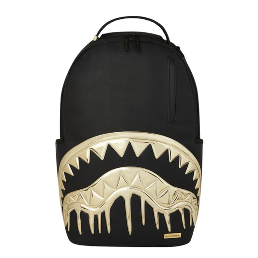 SPRAYGROUND Gold & Dangerous DLXSV Backpack featuring gold-tone shark-mouth graphic on black vegan leather with SPRAYGROUND logo detailing.