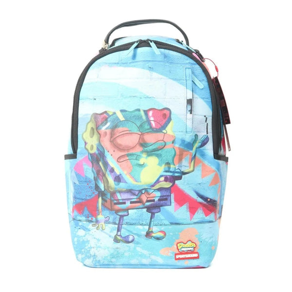 SPRAYGROUND Peanuts Joe Cool Reveal Checker DLXSV Backpack with Snoopy Joe Cool graphic on black-and-white checkerboard pattern and red SPRAYGROUND logo.