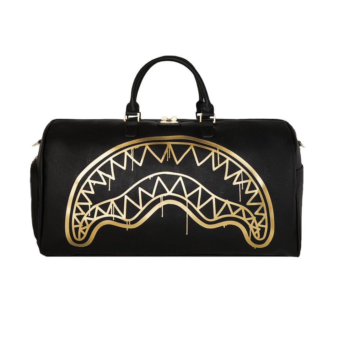 Sprayground That Gold Drap Duffel with gold-accented graphic, spacious main compartment, and reinforced handles.