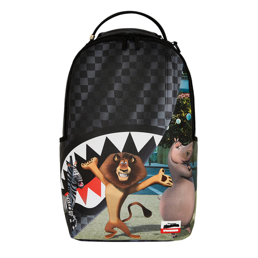 SPRAYGROUND Madagascar NYC Reveal DLXSV Backpack featuring Madagascar characters with curtain-reveal design and New York City backdrop on durable vegan leather








