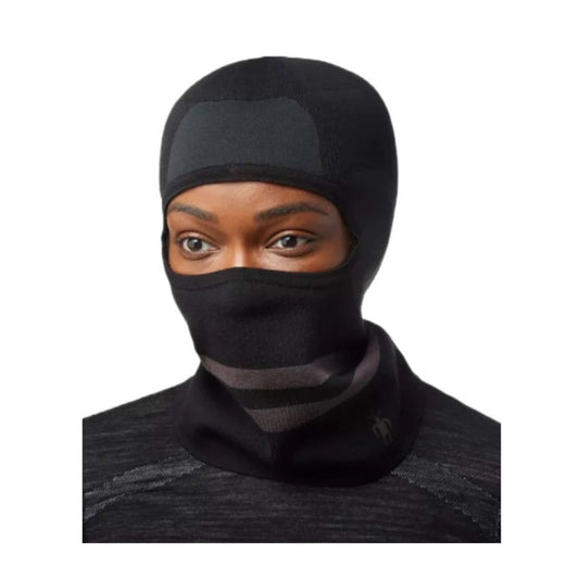 Smartwool Intraknit Merino Tech balaclava covering head and face, featuring breathable knit zones and snug fit, designed for cold-weather outdoor performance