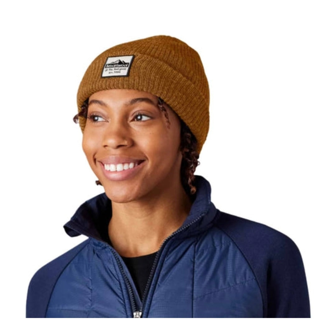 Unisex knit beanie featuring a soft merino wool blend construction, fold-over cuff, patch detail, and classic cold-weather styling for everyday wear