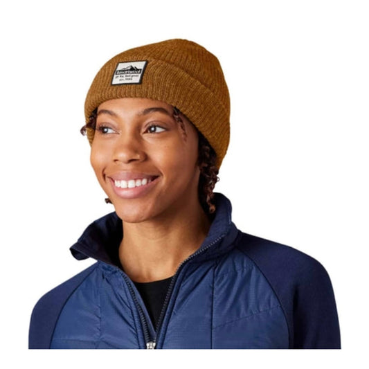 Unisex knit beanie featuring a soft merino wool blend construction, fold-over cuff, patch detail, and classic cold-weather styling for everyday wear