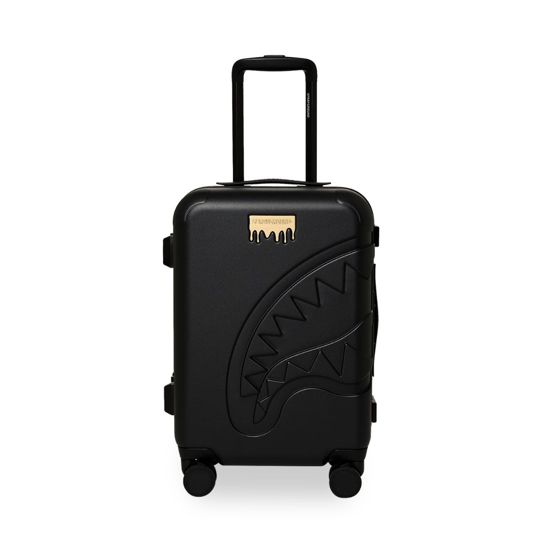 Sprayground Gold Brick LUXE carry-on luggage with metallic gold brick design, hard shell construction, spinner wheels, and telescopic handle for stylish travel