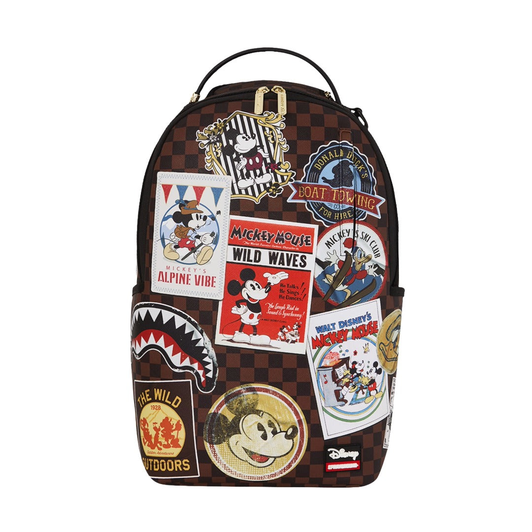 Sprayground Mickey Mouse Global Mogul backpack with colorful global patch graphics, featuring a structured faux leather design, zip compartments, and padded straps for everyday use