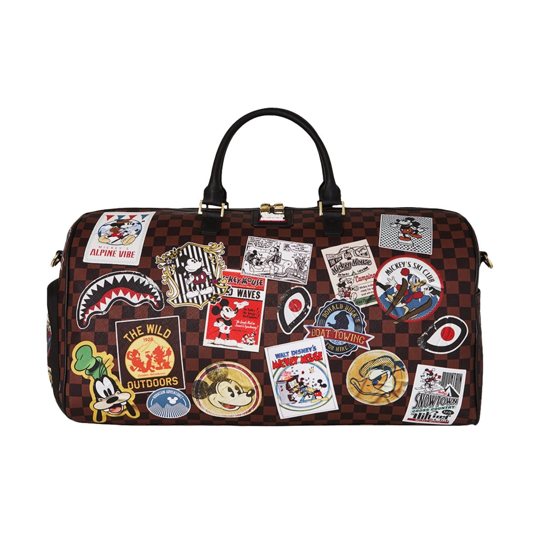 Sprayground duffel bag featuring Mickey Mouse Global Mogul graphic, with bold colorful design, dual handles, and shoulder strap for travel or everyday use