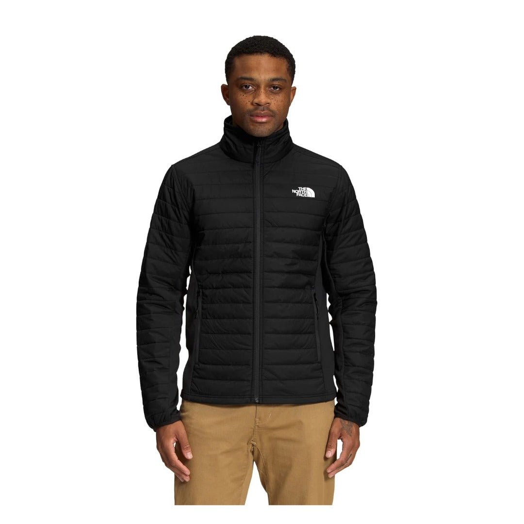 Man wearing a North Face Canyonlands hybrid jacket with insulated panels and stretch fleece, designed for mobility and warmth in cool conditions.