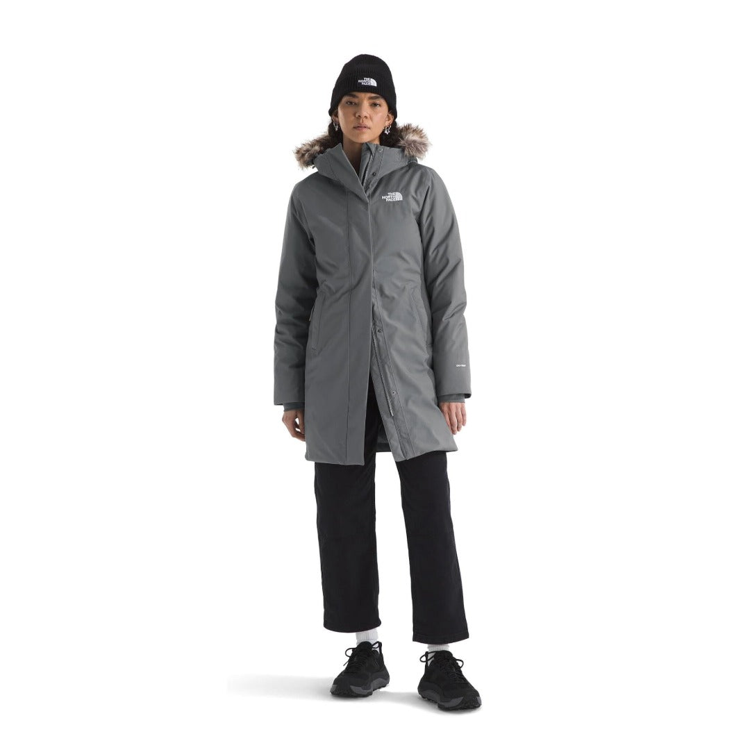 Women’s long insulated winter parka featuring a water-repellent outer shell, warm insulation, adjustable hood with faux-fur trim, full-length front zipper, storm flap, multiple pockets, and adjustable cuffs for cold-weather protection
