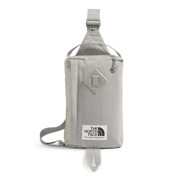 The North Face Berkeley Field Bag in beige with black strap and zippered compartments, styled as a compact crossbody bag.







