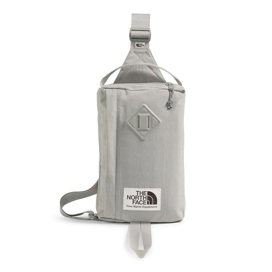 The North Face Berkeley Field Bag in beige with black strap and zippered compartments, styled as a compact crossbody bag.







