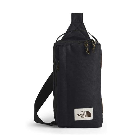 The North Face Berkeley Field Bag in beige with black strap and zippered compartments, styled as a compact crossbody bag.