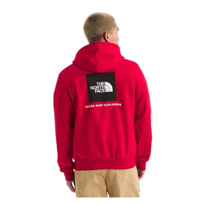 The North Face Men’s Evolution Box Hoodie in black with front logo on chest and large white “Never Stop Exploring” graphic on the back.
