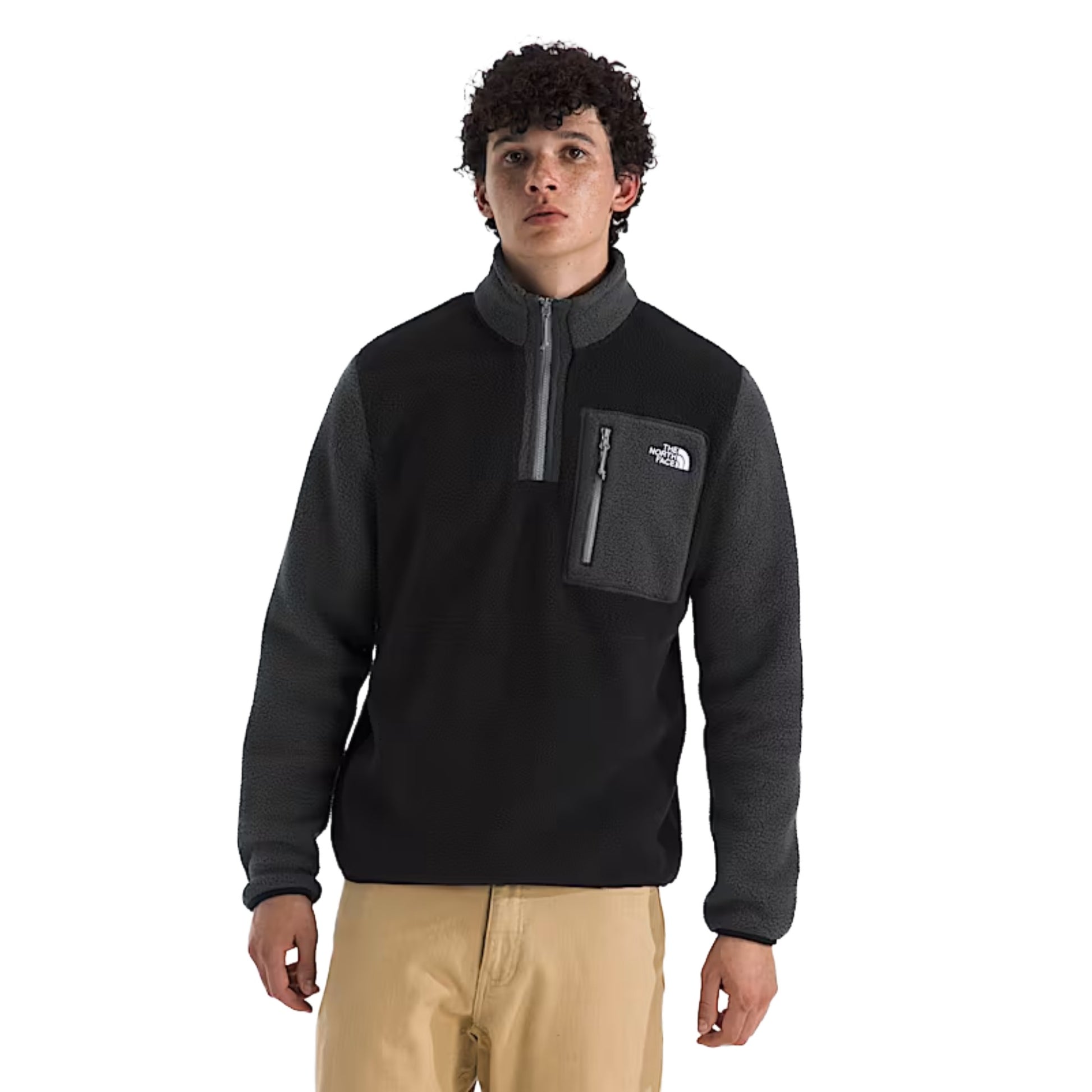Man wearing a black and asphalt North Face Yumiori quarter-zip fleece pullover with a stand collar, designed for lightweight warmth and casual outdoor wear.
