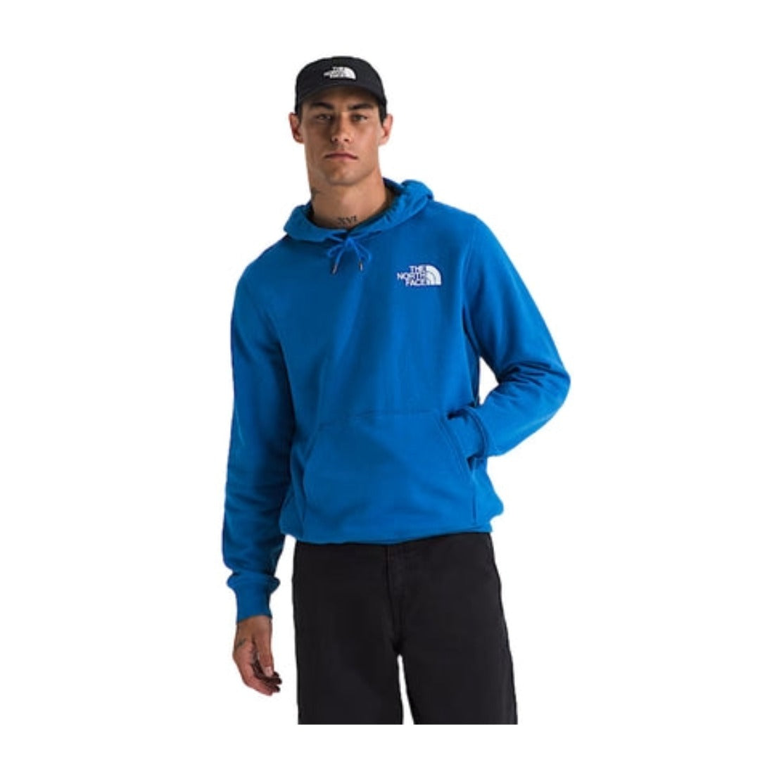 Man wearing a North Face pullover hoodie with a large box logo on the back, featuring a drawstring hood and kangaroo pocket for casual comfort.