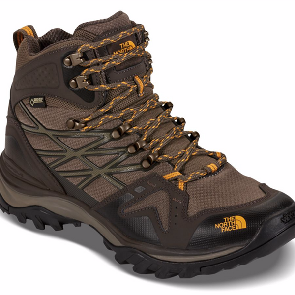 Men's mid-cut waterproof hiking boots featuring a leather and synthetic upper with a GORE-TEX® membrane, lace-up closure, reinforced toe cap, padded collar, cushioned EVA midsole, and a durable rubber outsole with aggressive trail lugs for hiking and backpacking