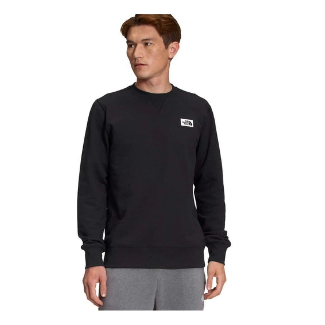 The North Face Men’s Heritage Patch Crew featuring soft fleece fabric, ribbed trim, and stitched heritage logo patch on a classic crewneck sweatshirt.