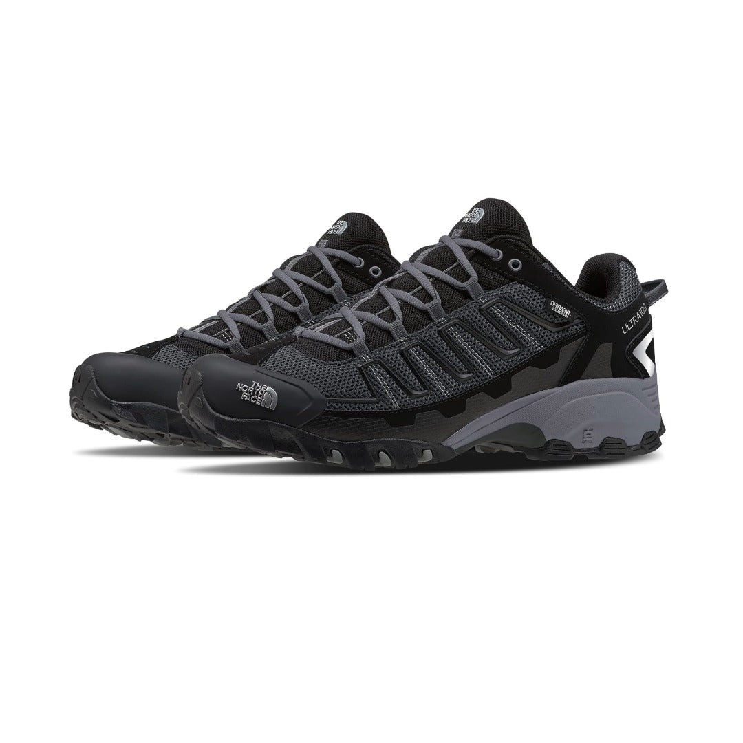 Men's wide-fit waterproof trail running shoe featuring a breathable mesh and synthetic upper, lace-up closure, reinforced toe cap, cushioned EVA midsole, padded collar, and a durable rubber outsole with aggressive lugs for hiking and trail running