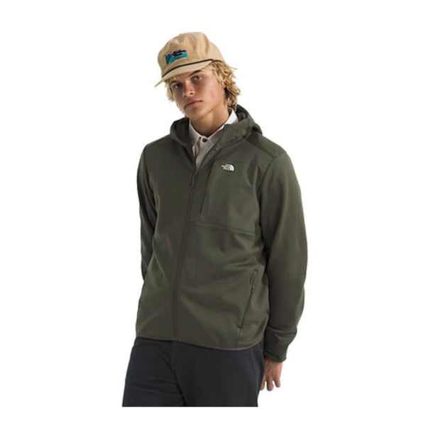 Person wearing a North Face full-zip fleece hoodie, showcasing a soft fabric, front zipper, and hood in a casual outdoor setting.