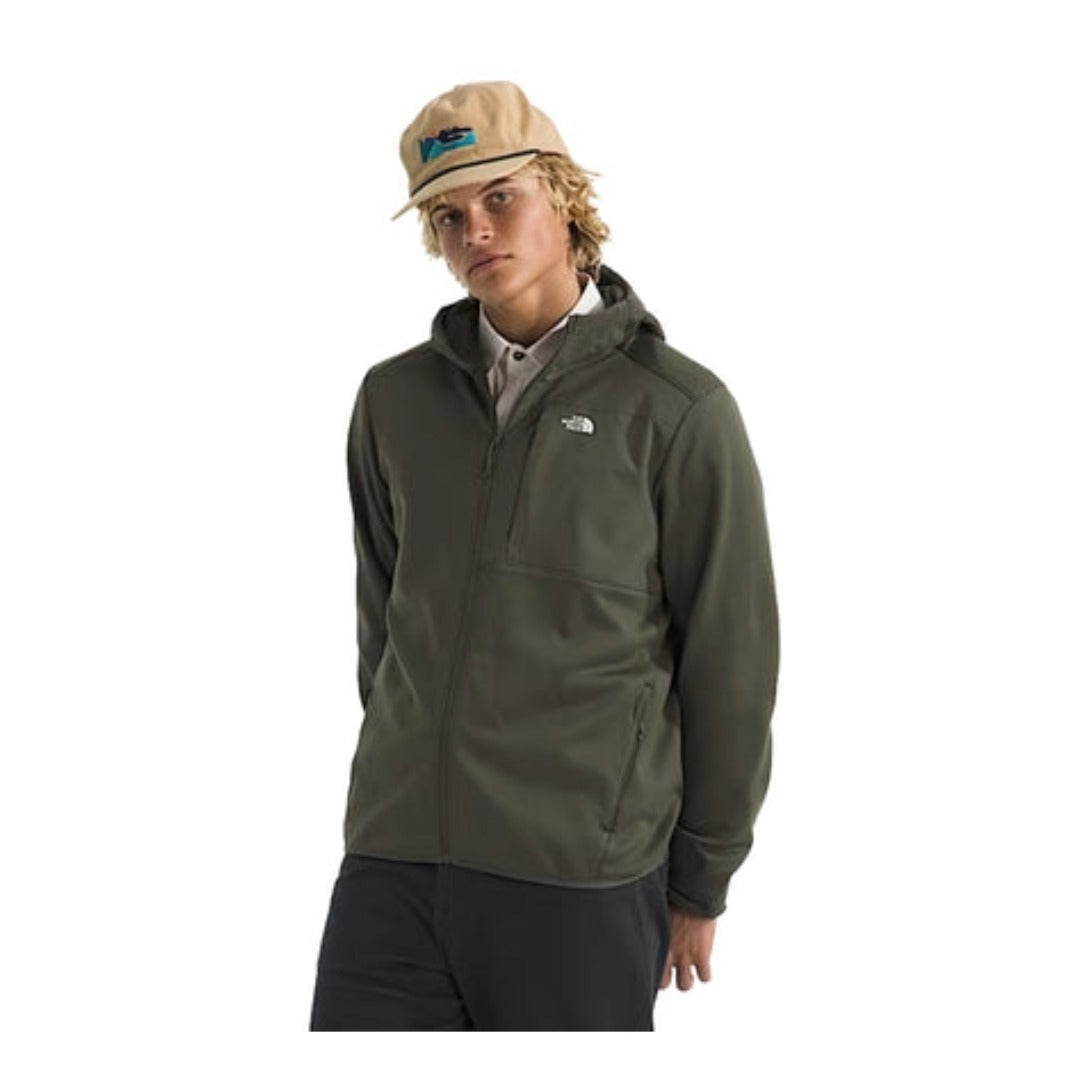 Person wearing a North Face full-zip fleece hoodie, showcasing a soft fabric, front zipper, and hood in a casual outdoor setting.