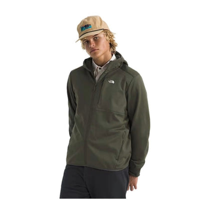 Person wearing a North Face full-zip fleece hoodie, showcasing a soft fabric, front zipper, and hood in a casual outdoor setting.