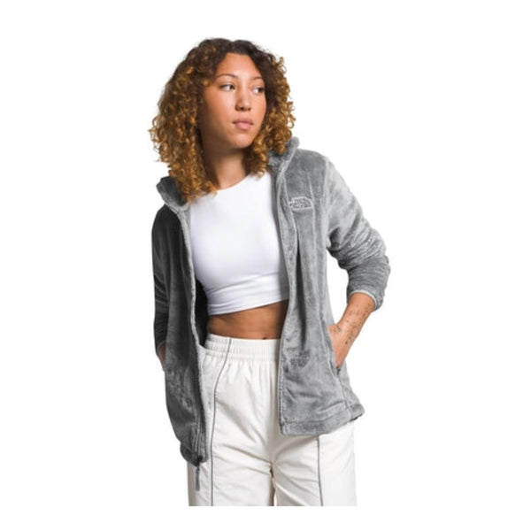 Woman wearing a North Face Osito fleece jacket with a full-zip front and plush texture, designed for warmth and comfort in cool weather.