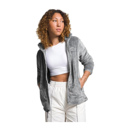 Woman wearing a North Face Osito fleece jacket with a full-zip front and plush texture, designed for warmth and comfort in cool weather.