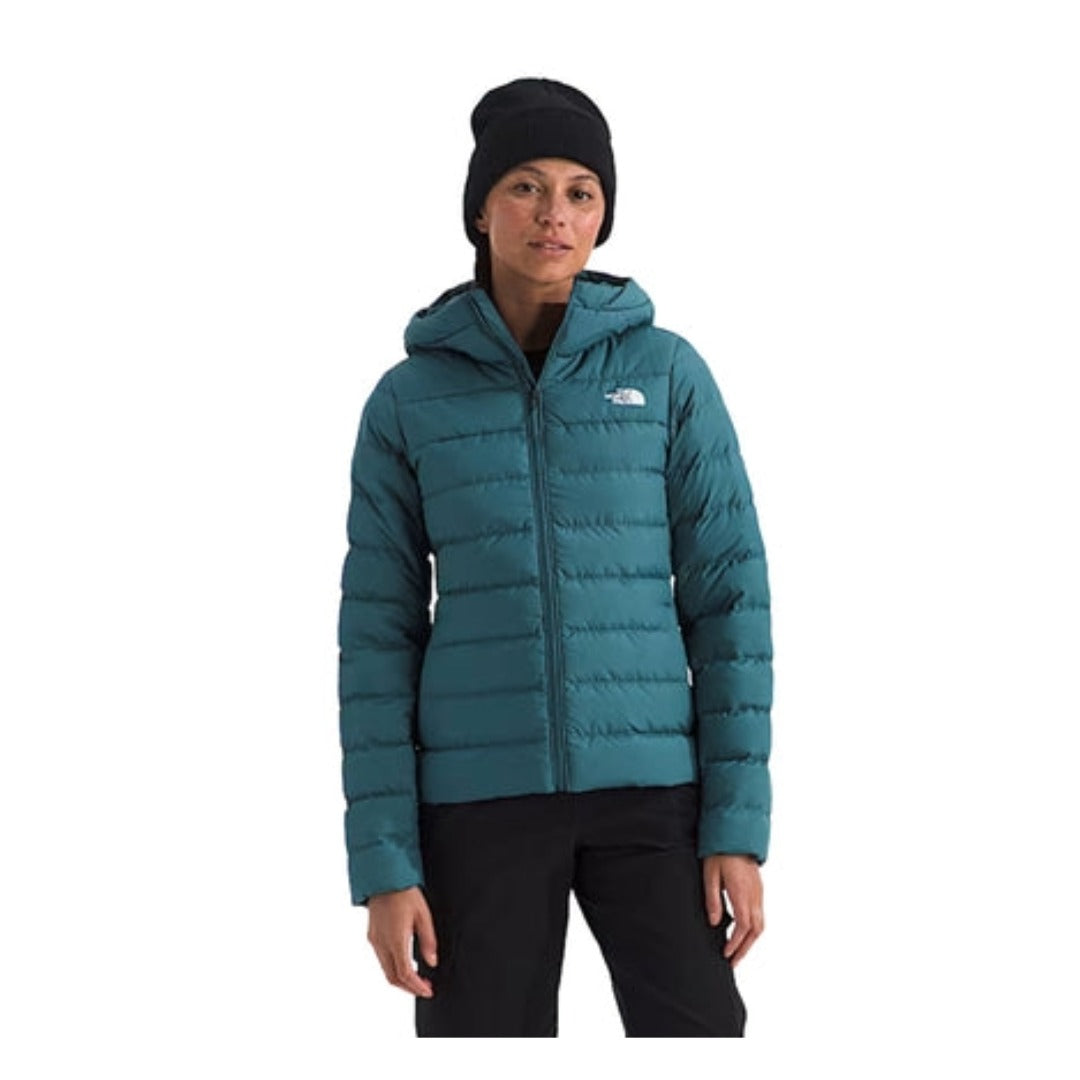 The North Face Women’s Aconcagua 3 Hoodie in black, featuring a quilted design, full front zip, and fitted hood for warmth and comfort.
