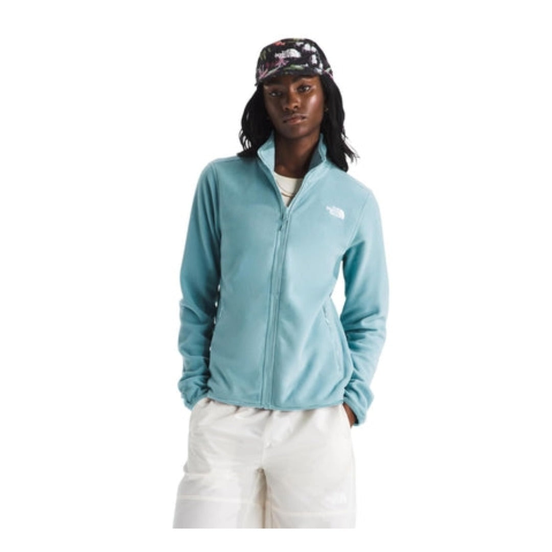 Woman wearing a North Face Glacier fleece jacket with a full-zip front and stand collar, designed for lightweight warmth in cool conditions.