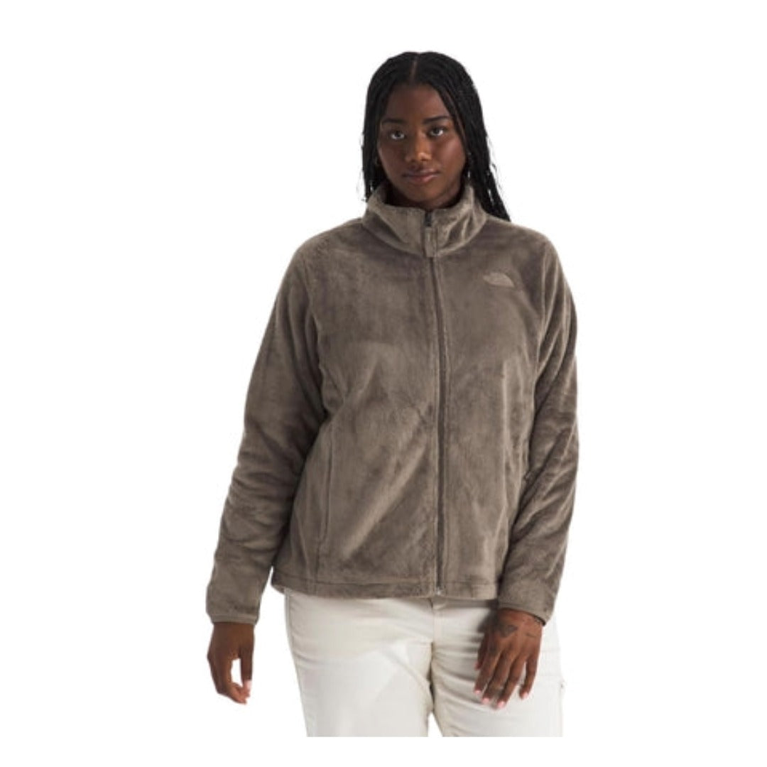 Woman wearing a North Face Osito  jacket with a full-zip front and plush texture, designed for warmth and comfort in cool weather.