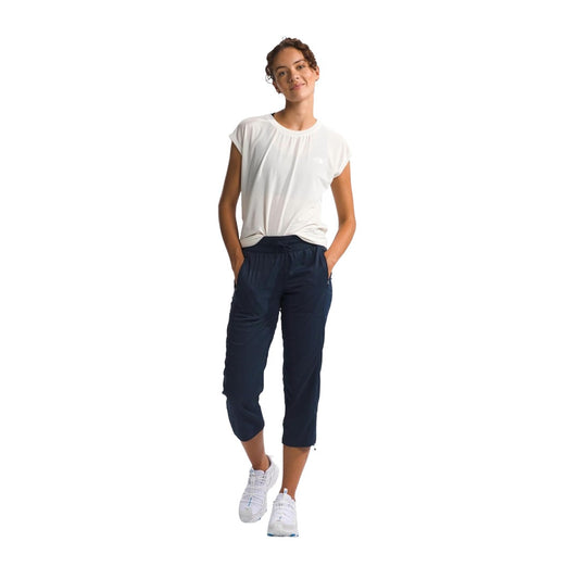Women’s capri-length outdoor pants featuring lightweight stretch fabric, a comfortable waistband, multiple pockets, and a relaxed fit for hiking, travel, and everyday wear