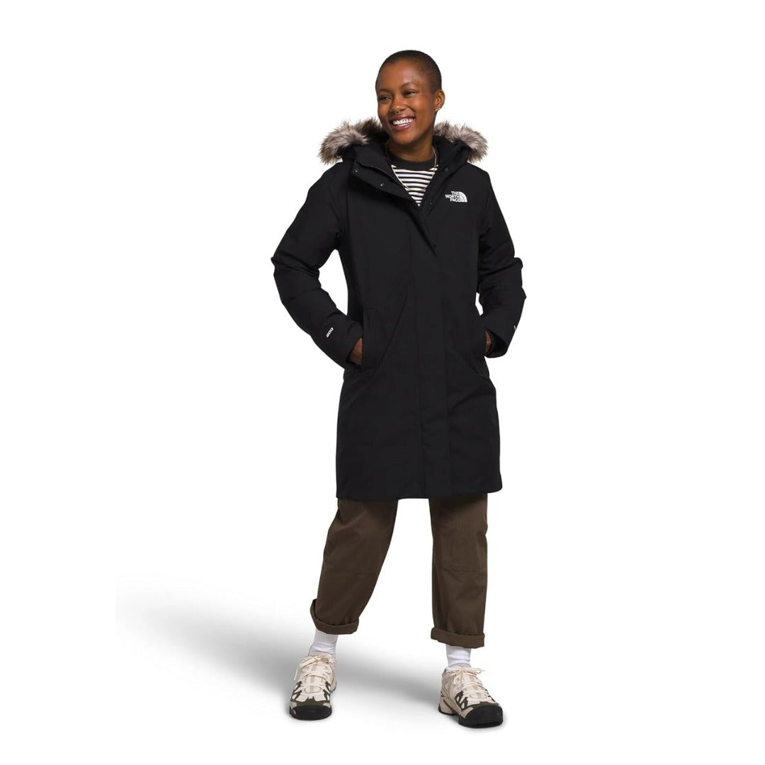 Women’s long insulated winter parka featuring a water-repellent outer shell, warm insulation, adjustable hood with faux-fur trim, full-length front zipper, storm flap, multiple pockets, and adjustable cuffs for cold-weather protection
