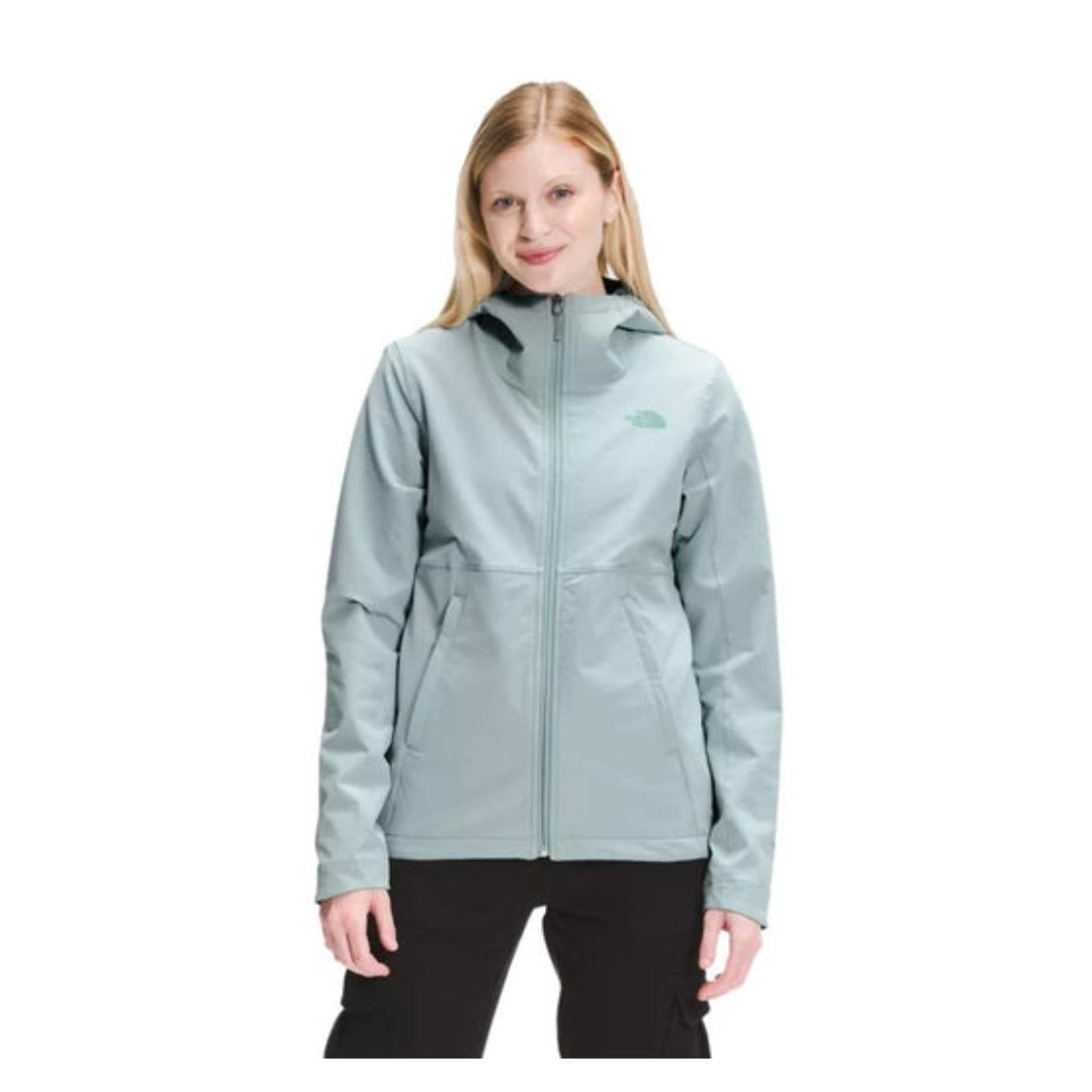 The North Face Women’s Shelbe Raschel Hoodie Jacket featuring wind-resistant soft-shell fabric, fleece lining, adjustable hood, and zippered hand pockets.