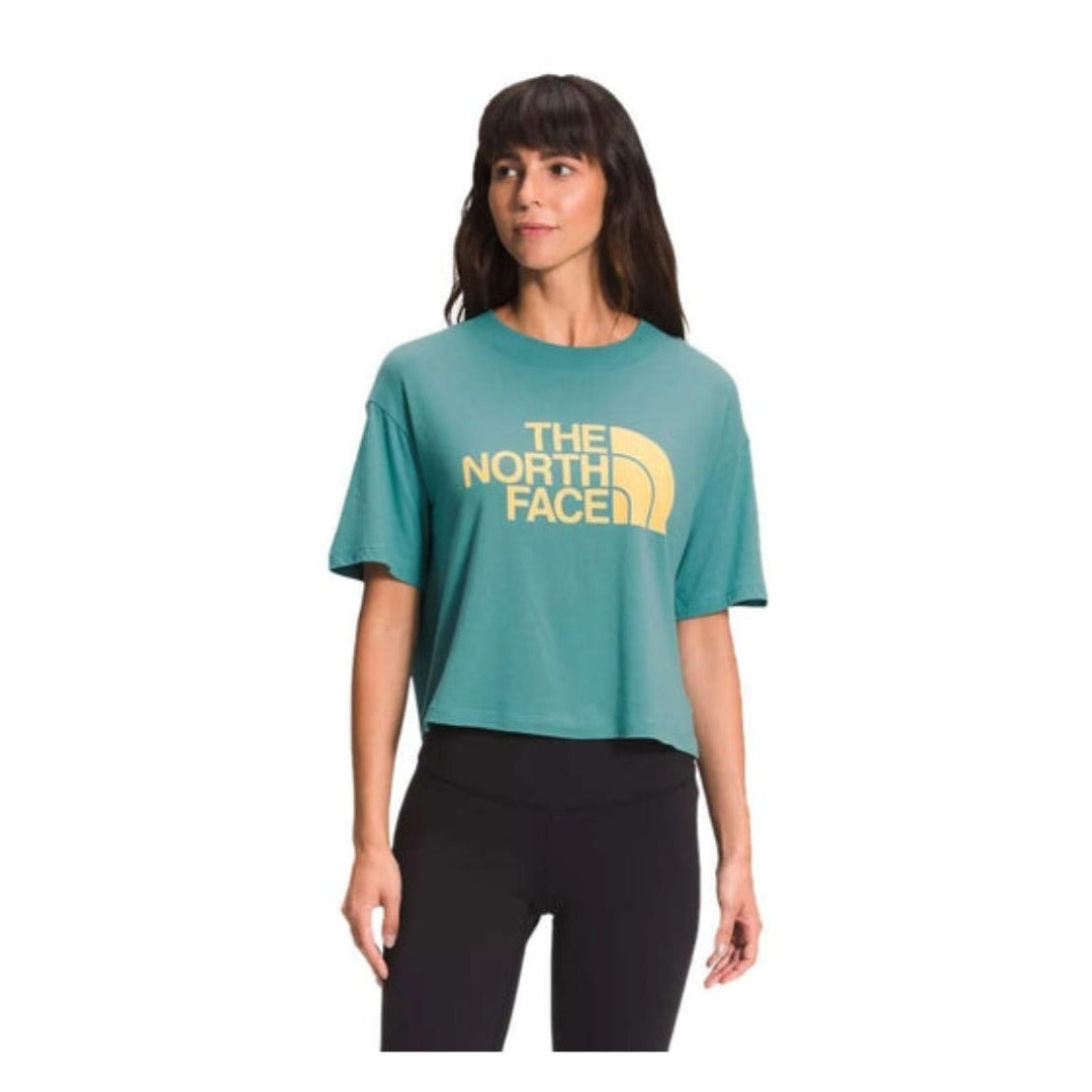 Front view of The North Face Women’s Short Sleeve Half Dome Cropped Tee in white with black Half Dome logo.