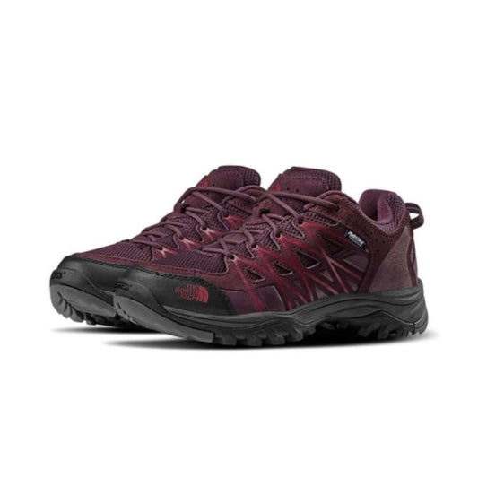 Women's waterproof hiking boots featuring a leather and synthetic upper, mid-cut lace-up design, reinforced toe cap, cushioned EVA midsole, padded collar, and rugged rubber outsole with multi-directional lugs for hiking and trekking