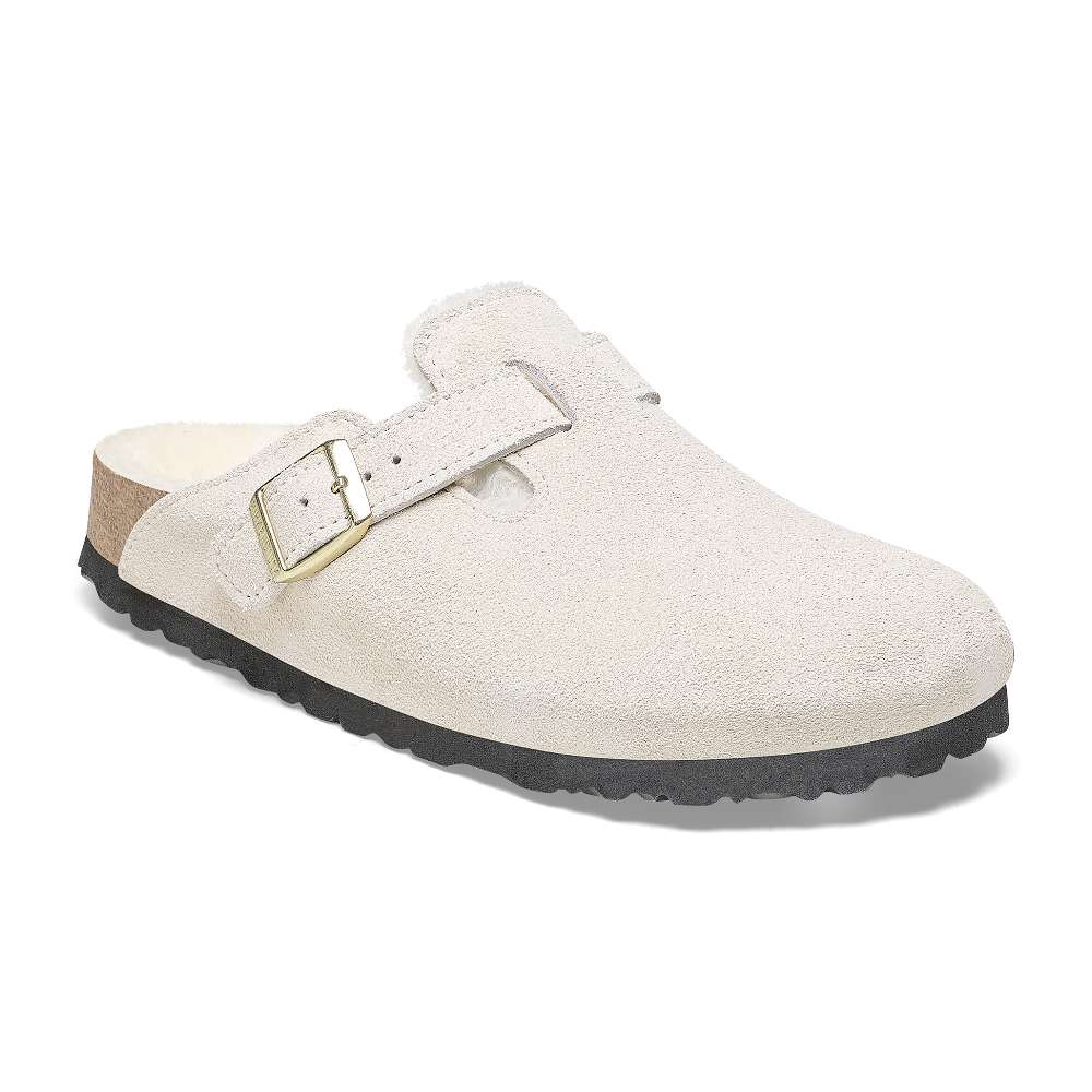 A pair of Birkenstock Boston VL Shearling sandals in antique white.