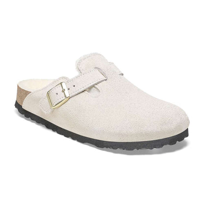 A pair of Birkenstock Boston VL Shearling sandals in antique white.