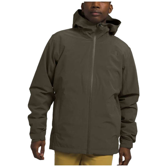 A man wearing The North Face Men’s ThermoBall™ Eco Triclimate® Jacket in taupe green, braving the elements.