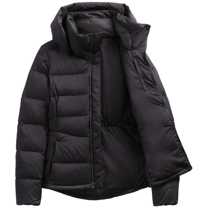 A stylish North Face Women's Metropolis Jacket in sleek black, worn by a woman against a snowy backdrop.